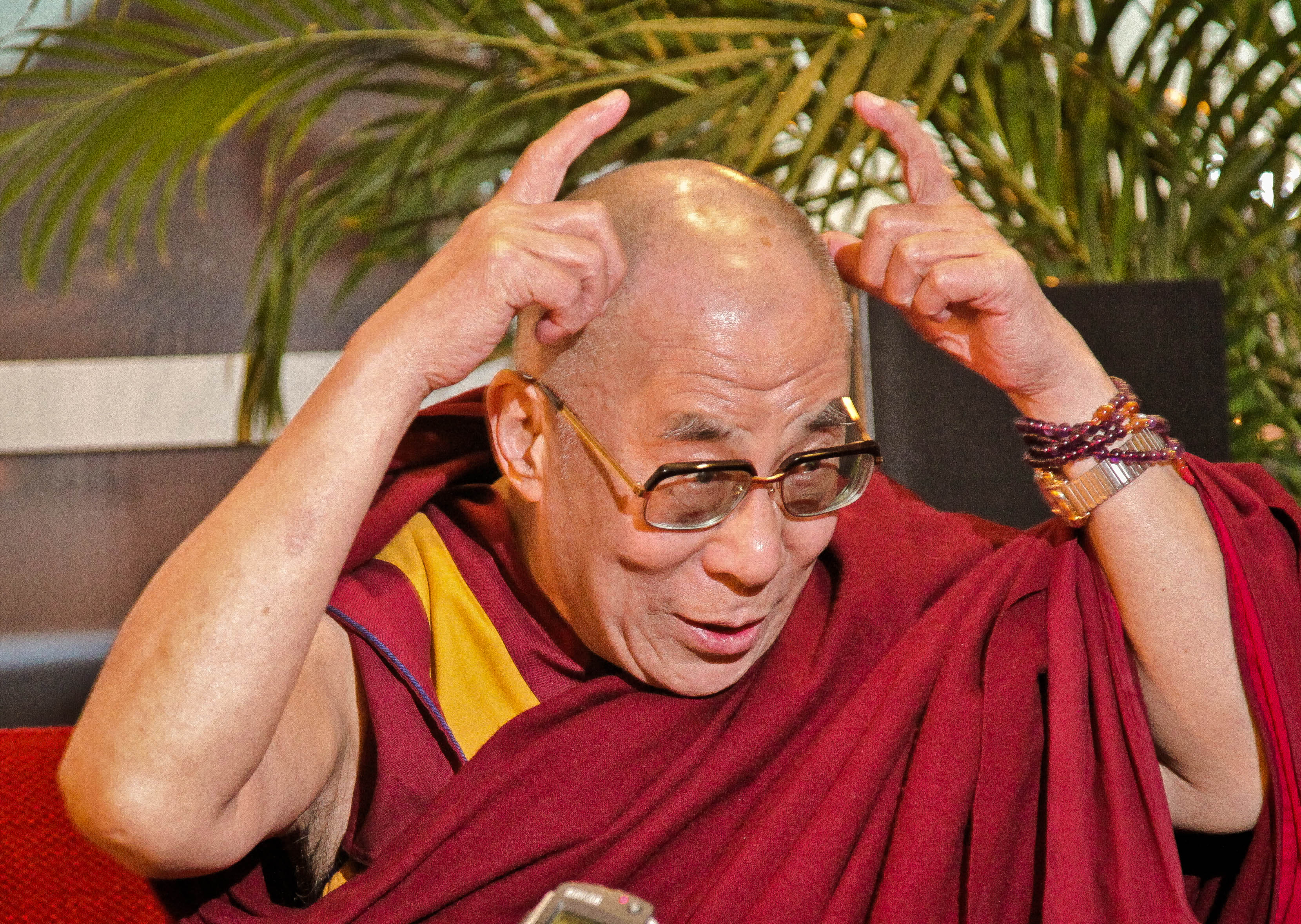 “China says I am a demon, with horns like this.” The Dalai Lama at a press conference in Sweden, 2011. Photo: Erik Törner, used under Creative Commons Licence.